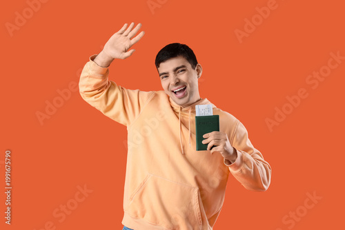 Happy young man with passpo...