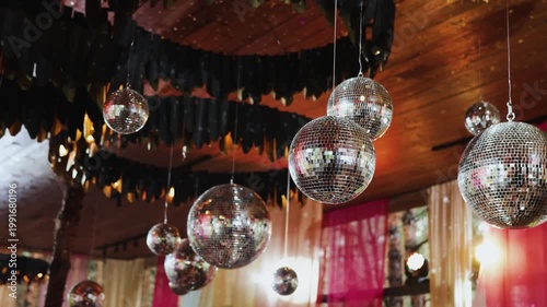 Festival canopy decorated with disco balls, colorful ribbons and sun glare, disco decor, retro birthday