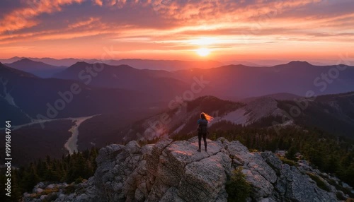 Tourist captures breathtaking sunrise over a vast national park from a majestic mountaintop