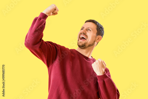 Happy young man on yellow b...