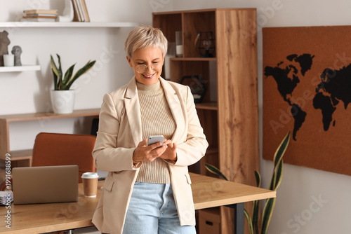 Mature businesswoman using ...