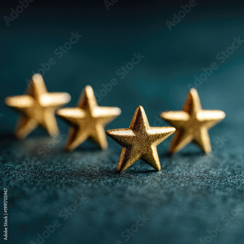 Golden stars in a row on a dark surface.