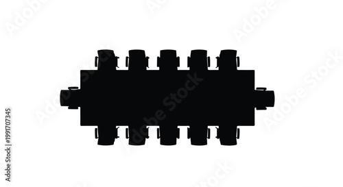 Top view silhouette of an empty long conference table in a boardroom.