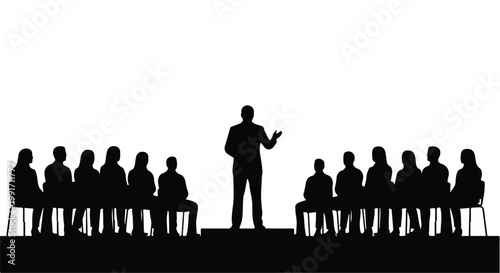 Silhouette of a professional speaker addressing a seated audience in a seminar.