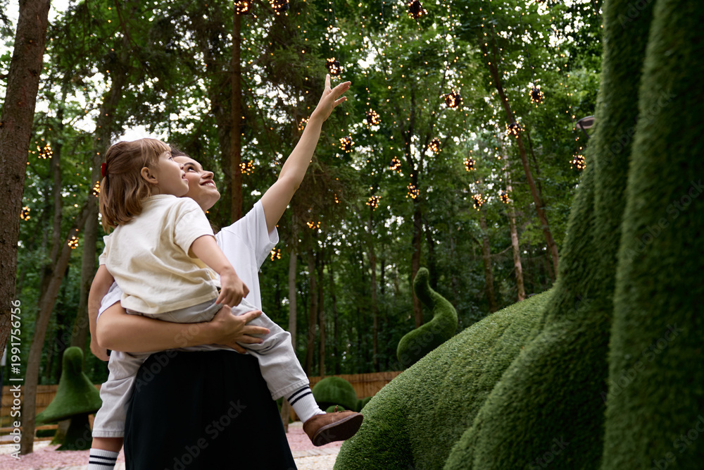 Fototapeta premium Joyful moments in an enchanting amusement park with mother and daughter
