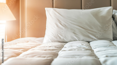 Cozy Bed with Pillow A soft pillow rests atop a well-made bed. Capturing a feeling of tranquility and relaxation.