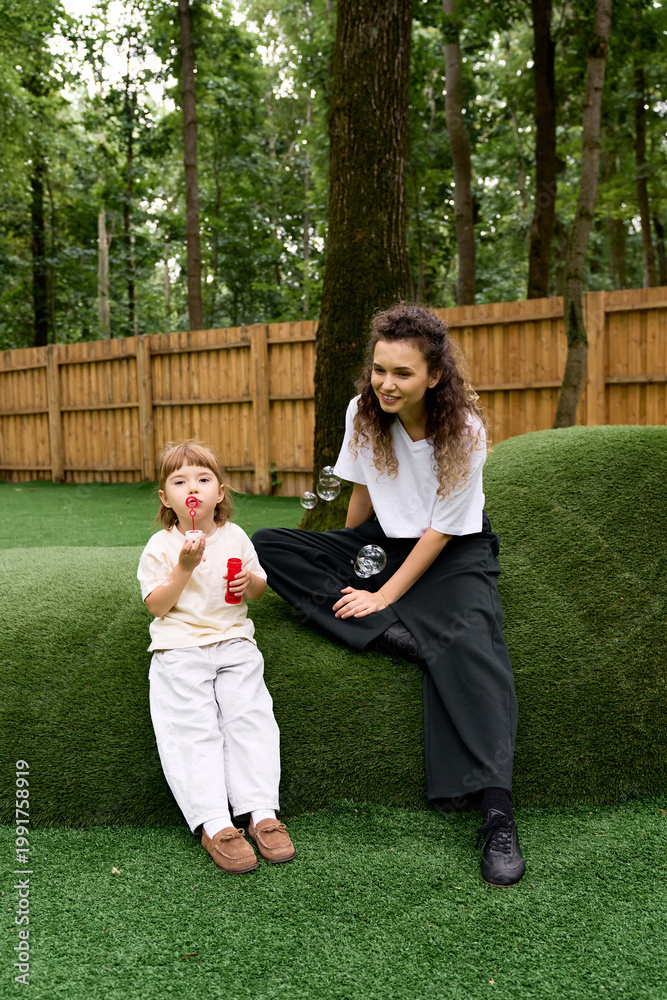 Obraz premium Joyful moments of a mother and daughter enjoying their day at the amusement park