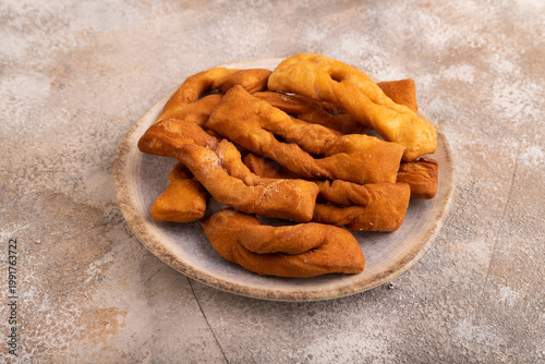 Crunchy biscuit Brushwood cookies on brown concrete, side view, close up