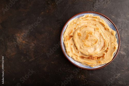 Stack of Plain Fried pancakes on black concrete. top view, flat lay, copy space