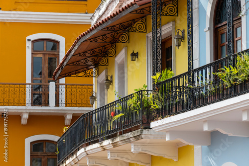 Colorful building facades featuring decorative wrought-iron balconies and traditional window awnings, showcasing the rich historic architecture of Panama city's old quarter - stock photo
