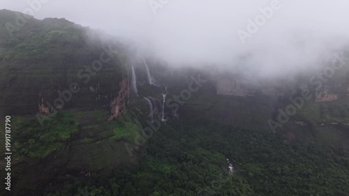 Moving Drone shot of a Huge explosive waterfall shot during heavy monsoon. Three tier waterfall. Tallest waterfall in India. Drone clip 4K60