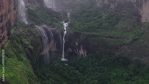 Moving Drone shot of a Huge explosive waterfall shot during heavy monsoon. Three tier waterfall. Tallest waterfall in India. Drone clip 4K60