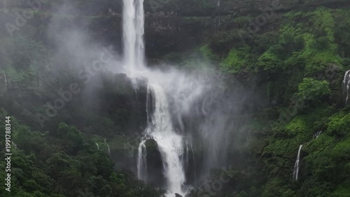 Moving Drone shot of a Huge explosive waterfall shot during heavy monsoon. Three tier waterfall. Tallest waterfall in India. Drone clip 4K60