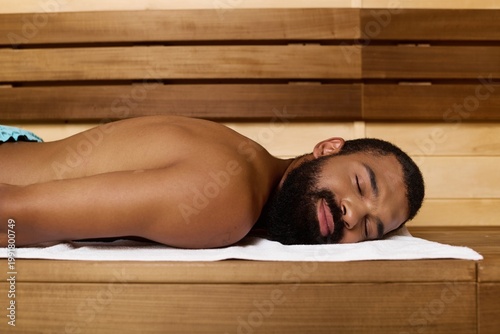 Εκτύπωση καμβά Relaxing in the soothing warmth of a spa, a man enjoys tranquility and wellness