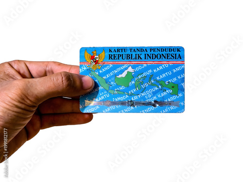 Hand holding an Indonesian national identity card isolated on a white background.