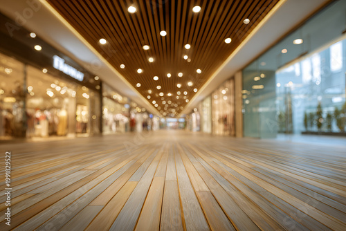 Empty Modern Shopping Mall Interior with Wooden Floor and Blurred Shops.