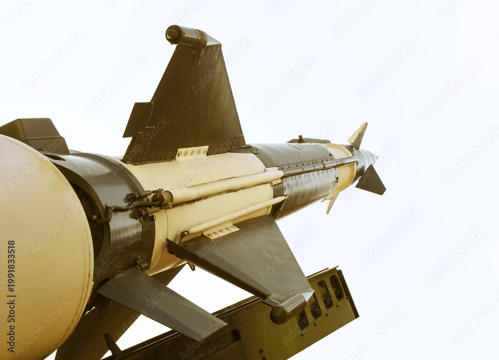 Obraz premium Anti-aircraft cruise missiles on a launcher on blue sky background missiles are aimed to sky at day Nuclear bomb, chemical weapons, missile defense system of salvo fire Metallic missile rocket