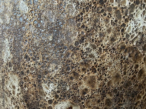 Fotografía Volcanic rock surface showing rough porous texture and bubbling patterns with an