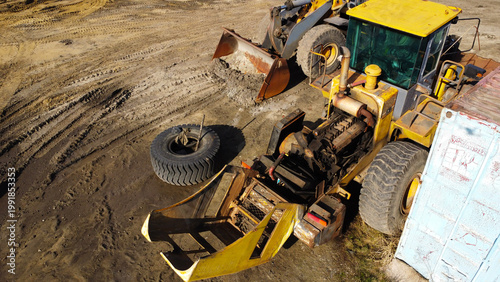 Heavy Wheel Loader Undergoing Engine Maintenance at Construction Site