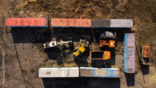 Top-Down Aerial View of Construction Machinery and Shipping Containers