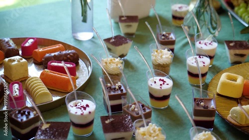 Variety of Gourmet Mini Desserts and Mousse Cakes on Buffet Table for Event Catering.