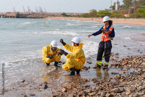 Photos Workers conduct water testing at the shore in a coastal area during daytime