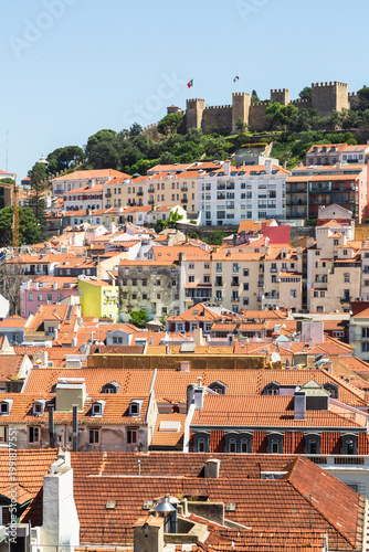 Lisbon, Portugal - 15 April 2024: View over the city center of Lisbon with historic fortress Castelo de Sao Jorge on a hill and houses with colorful facades underneath