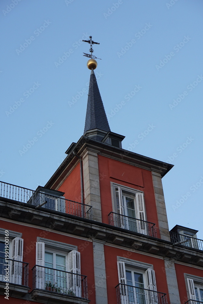 Fototapeta premium Plaza Mayor Madrid Slate Spire Tower with Golden Orb and Cross Against Blue Sky