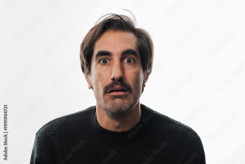 Obraz premium Man with a surprised expression in a bright studio setting