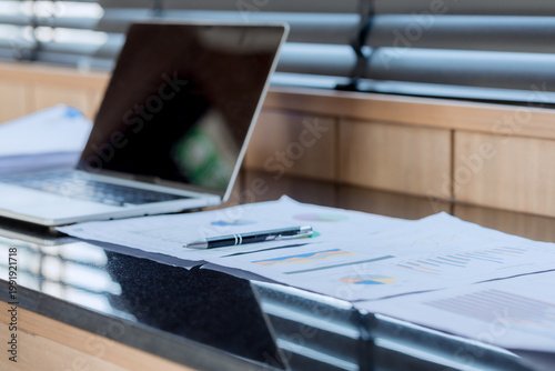 Smiling businesswoman working on laptop in café, enjoying hot drink, analyzing charts, planning projects, and staying connected in a modern professional lifestyle.
