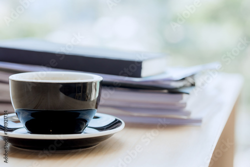 Smiling businesswoman working on laptop in café, enjoying hot drink, analyzing charts, planning projects, and staying connected in a modern professional lifestyle.
