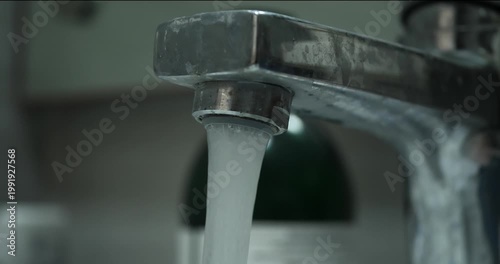 close up of flowing tap water with blurred background