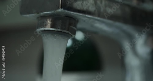 close up of flowing tap water with blurred background