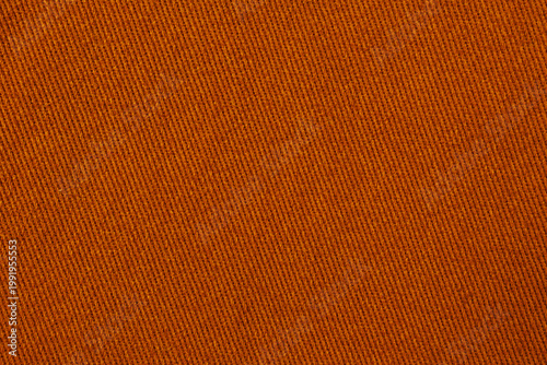 Warm orange denim fabric texture with diagonal twill weave vibrant textile background