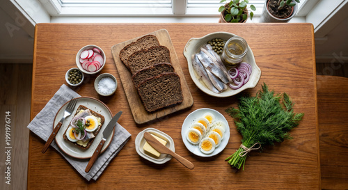 Overhead flat lay of Smorrebrod ingredients on smooth Danish teak wood