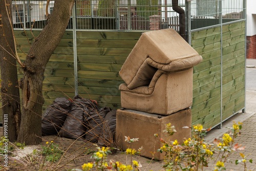 Photos Discarded old armchairs near trash area bulky waste improper disposal urban envi