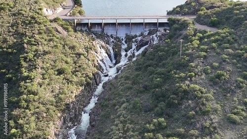 Panoramic aerial view of a large dam and water reservoir in San Luis, Argentina.