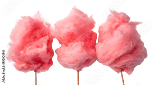 Three fluffy pink cotton candy clouds on wooden sticks against a stark black background high quality