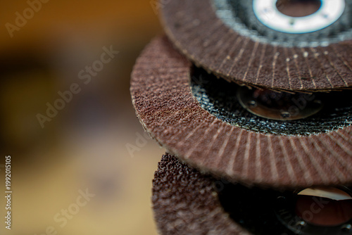 Konstfotografi Macro close-up of layered flap abrasive discs, showing rough sanding material and circular metal center for grinding or surface finishing