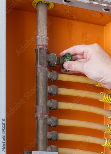 Man turning a water shutoff or a main valve