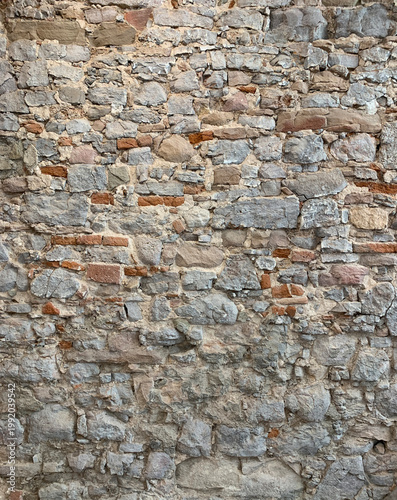 Seamless looking stone wall texture, natural pattern background with rough surface and neutral colors