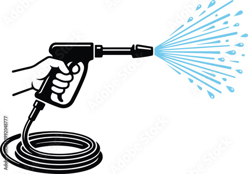 Hand holding a pressure washer spraying water in a fan pattern with pressure cleaning equipment mechanism