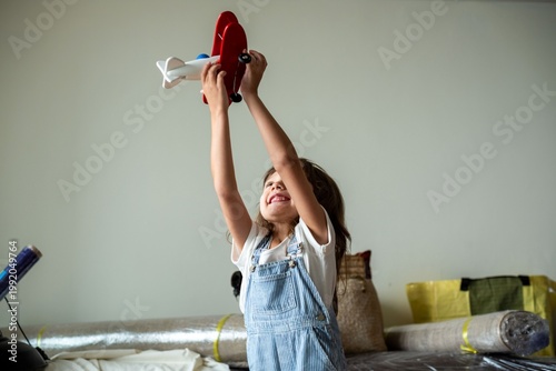 Foto Joyful child playing airplane photo