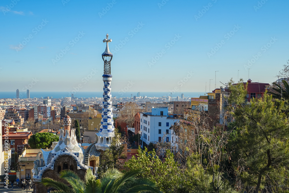 Obraz premium Park Guell,Barcelona,Spain,View of Park Guell with ornate columns and Barcelona cityscape in the background