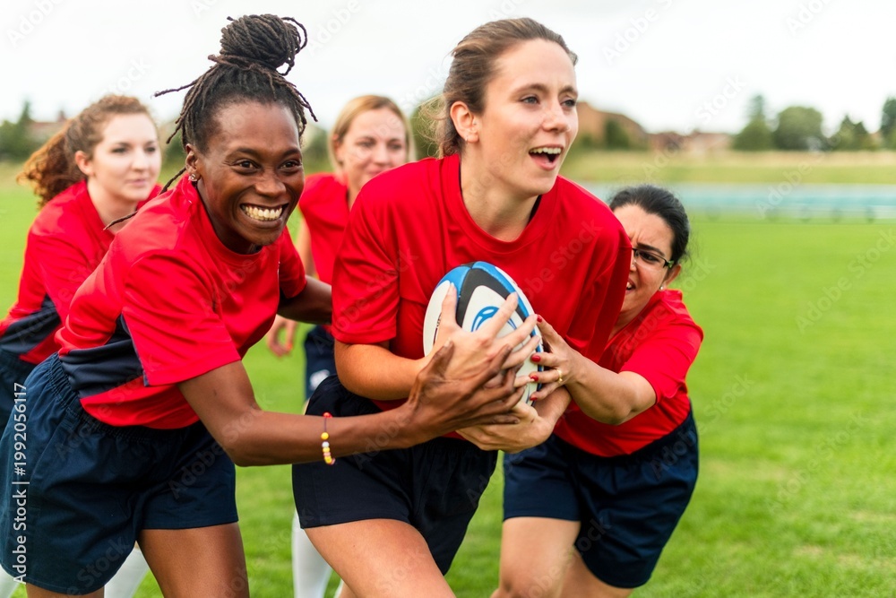 Fototapeta premium Women playing rugby outdoors photo