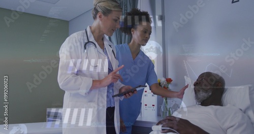 Pointing tablet, doctor in white coat explaining at bedside, nurse in blue scrubs reaching patient