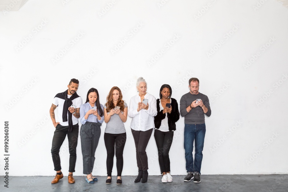 Obraz premium Diverse group using smartphones photo