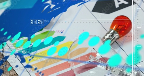 Lying clear bulb with orange cap on studio desk, with swatches and cyan bokeh, copy space