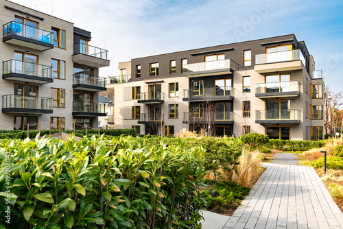 Beautiful new block house in the blooming garden. Housing development in Europe
