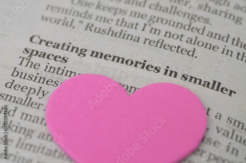 Emotional connection and creating memories concept with pink heart on text.